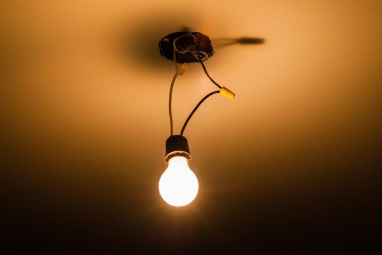 a flickering light bulb with exposed wires.