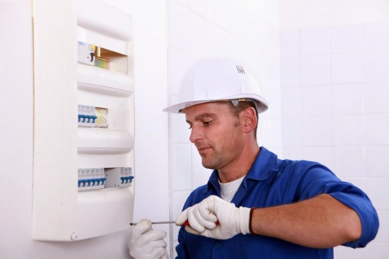 An electrician repairing a circuit breaker.