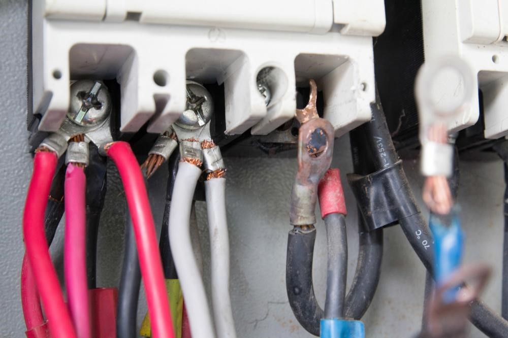 A control panel with old electric wiring system.