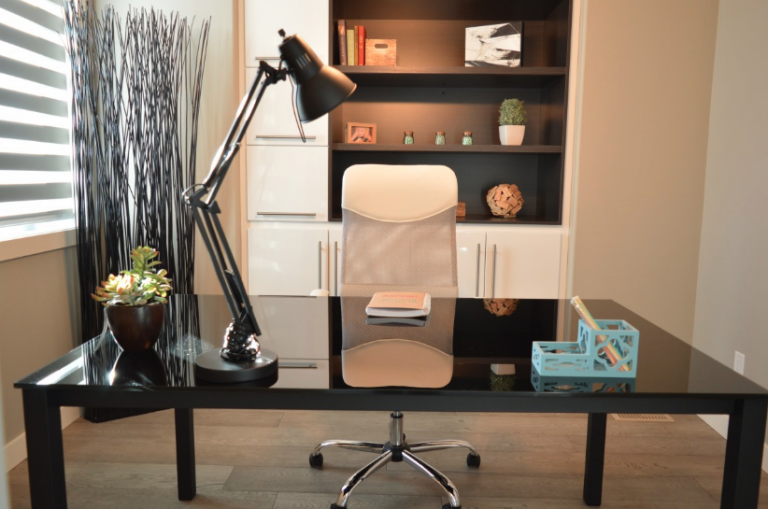 Home office with desk lamp and chair.