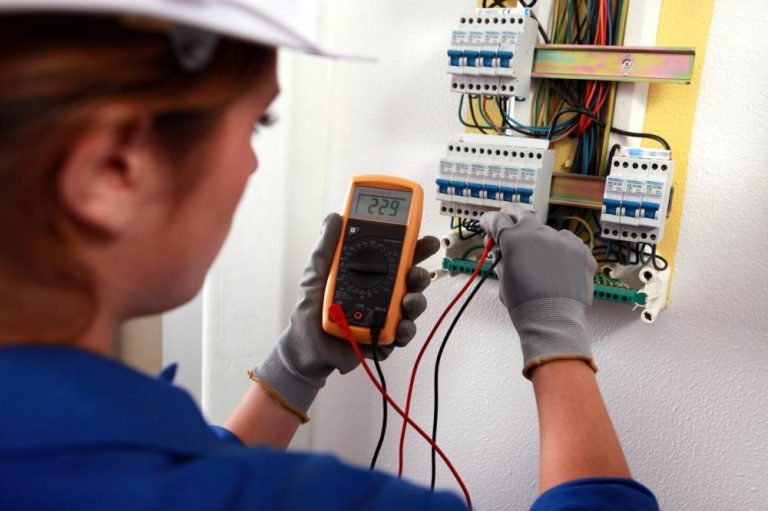 Professional electrician fixing a fuse box